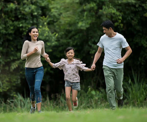 Parents and their daughter running through a field to celebrate completing the FireStory Communication Course for families in Nashville, TN.