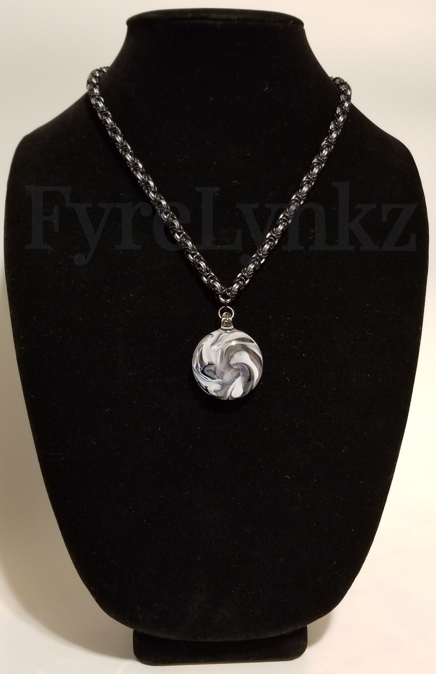 Byzantine Necklace in black and platinum colored rings with a glass focal handcrafted by Ozzie's Glass Gallery - shown on a jewelry display bust
