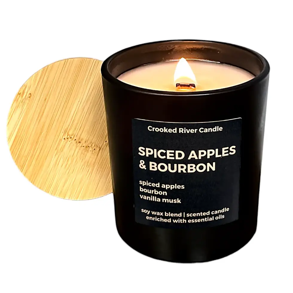 Thumbnail: Lit Spiced Apples & Bourbon Candle in matte black jar with bamboo lid and wood wick
