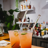 Two mixed drinks waiting at the bar to be enjoyed