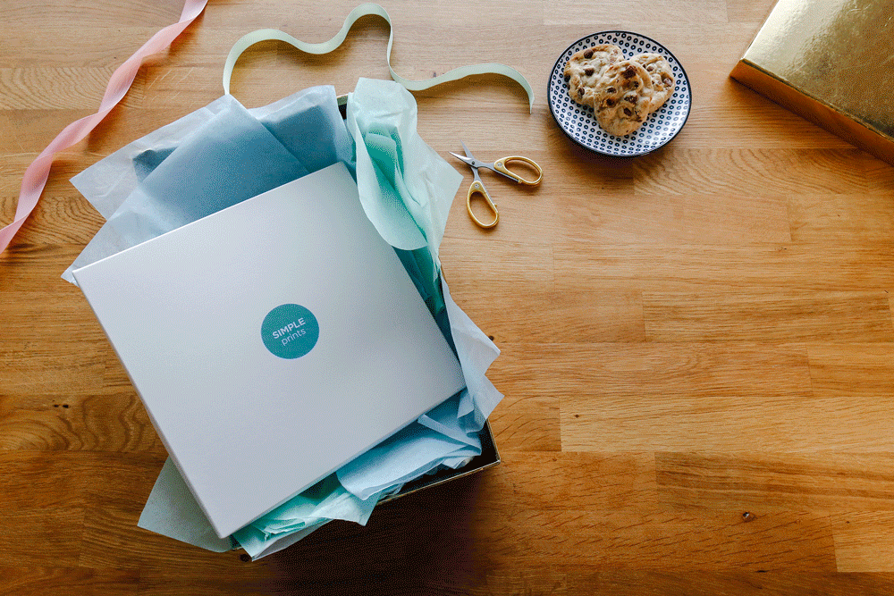 Gif of person opening a box to fins SimplePrints photo Book