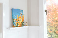 Canves prints of flowers on top of a shelf