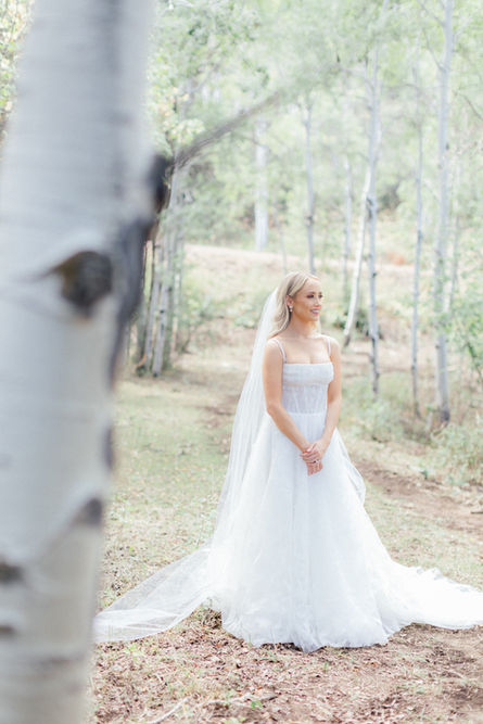 A bride patiently awaiting to approach her groom for their first look.