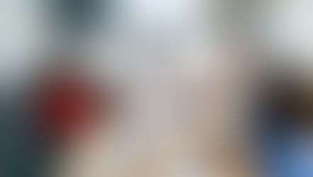 Real estate agent collaborating with a brokerage support team on a laptop, reviewing marketing materials and transaction timelines to improve productivity.