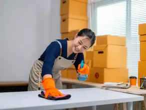 woman cleaning a desk for move out
