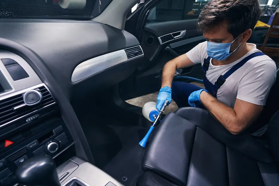 man in service station doing car cabin dry cleaning