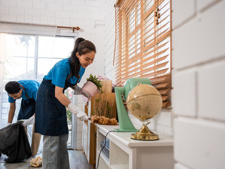 Asian young man and woman cleaning service worker work in living room.