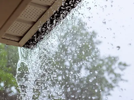 During a downpour, water escapes from the over gutters