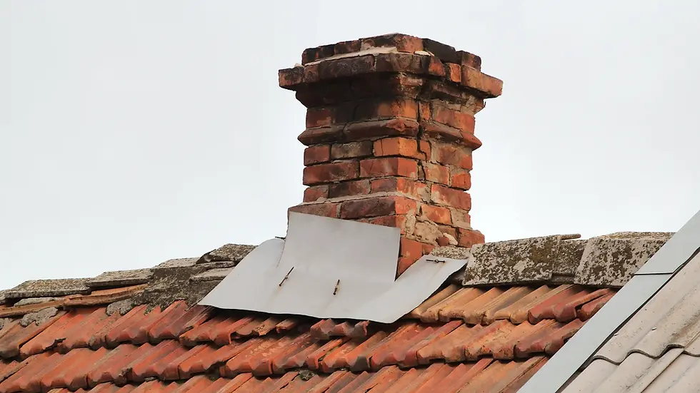 old red brick chimney on tiled roof and flashing failing