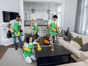Deep cleaning the house - Multiracial cleaners using modern tools for tidying up room