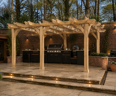 The Woodland Kitchen Pergola, featuring a handcrafted timber pergola with festoon lighting, built-in BBQ, ceramic grill, outdoor sink and storage units on a raised natural stone patio.