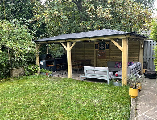Outdoor seating area and kitchen under a pyramid gazebo