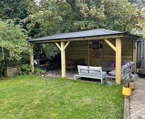 Outdoor seating area and kitchen under a pyramid gazebo