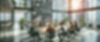 A diverse group of entrepreneurs collaborating around a table in a modern, well-lit office, surrounded by laptops, coffee mugs, and a motivational atmosphere.