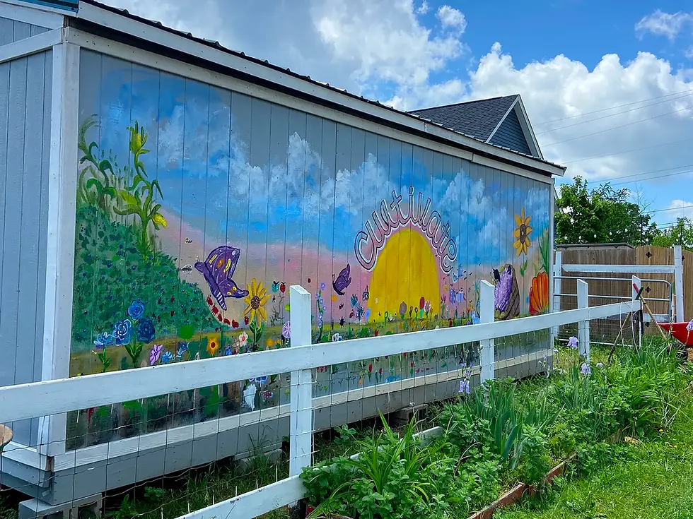 A mural on the site of a storgage shed depicting a sunrise over a flowering garden with the word, "Cultivate".
