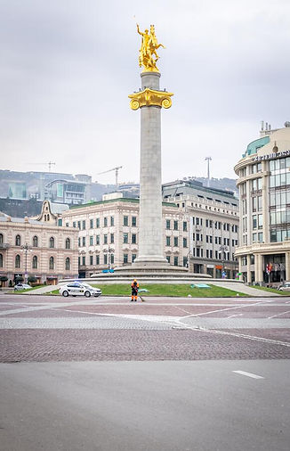 vertical-image-empty-liberty-square-statue-no-traffic-person-middle-sweeping-street-tbilis