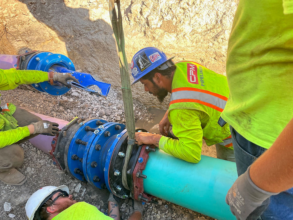 Field crew working on a pipe connection during an installation