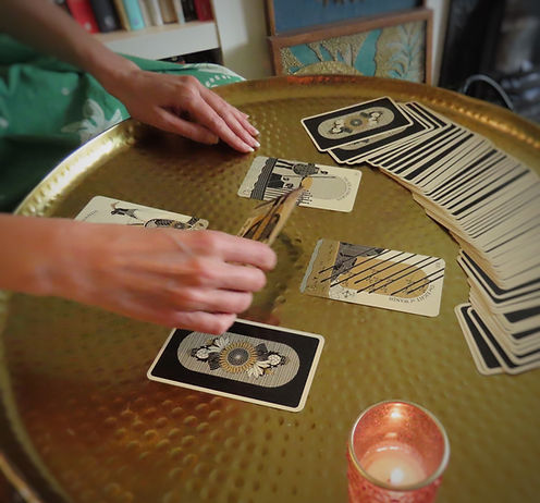 Debs Allen TOMAR tarot, hands with tarot cards performing a tarot reading