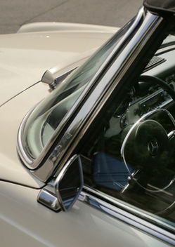 Windshield frame and cream hood of the Mercedes-Benz 280SL at Angels Touch Restoration.