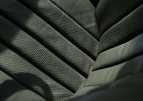 Close-up of black perforated seat upholstery in the Mercedes-Benz 280SL at Angels Touch Restoration.