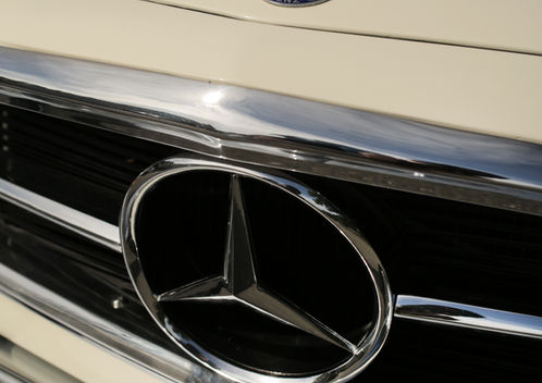 Hood emblem and chrome star grille on the cream Mercedes-Benz 280SL at Angels Touch Restoration.