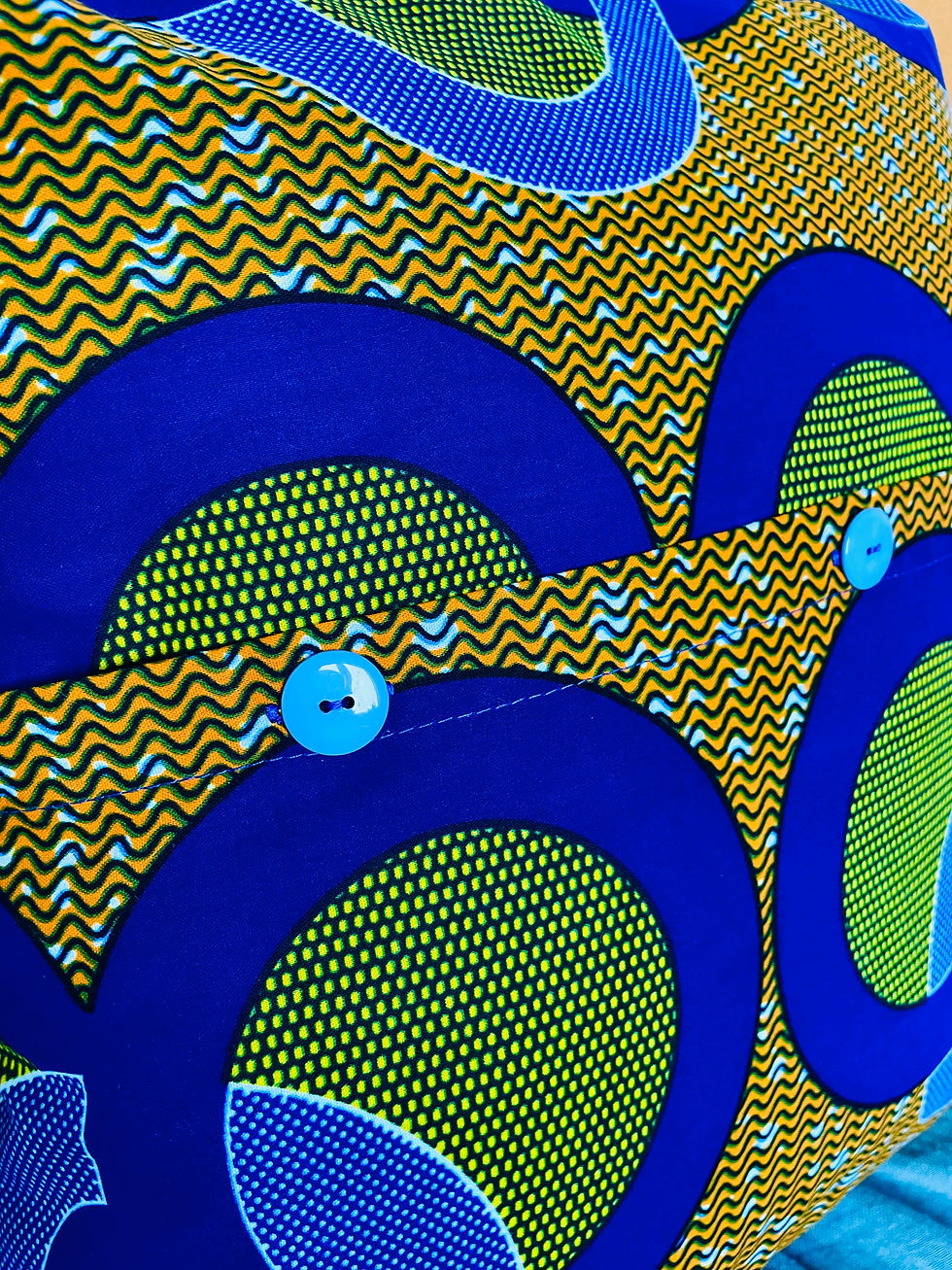 Thumbnail: Blue and yellow African wax print cushion cover button detail.