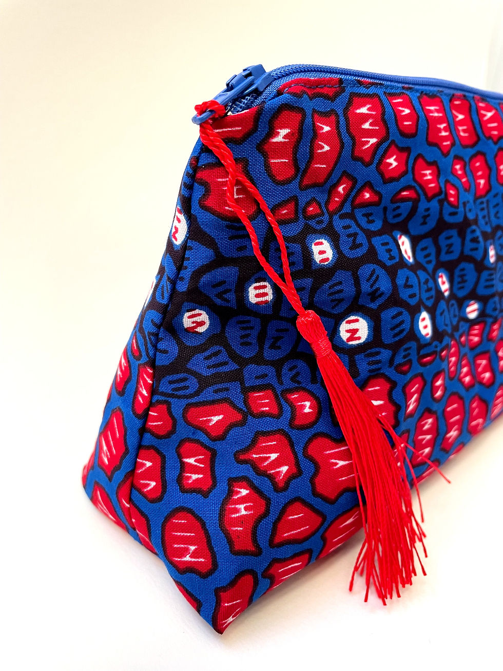 Handmade African wax print cosmetics bag in red and blue