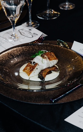 Private chef serving luxury plated dishes at an intimate table event by S&G Private Events.
