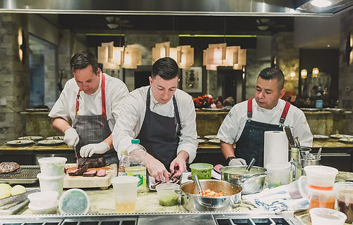 S&G Private Events staff: three chefs preparing catering for a private event.