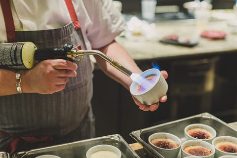 Personal chef preparing gourmet dessert at luxury event kitchen with plated dishes ready for guests – S&G Private Events catering