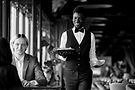 smiling-waiter-bringing-food-on-tray-to-guests-enj-opt_edited.jpg