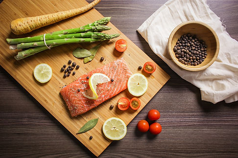 Ingredients for salmon including a filet, lemon, and aspargus
