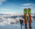 San Cassiano a faamily friendly location as recomended by ALPY winter travel experts, to take a moment like seen in the picture to take in the view of San Cassiano Alpine beuty. ALso seen two skis and ski sticks.