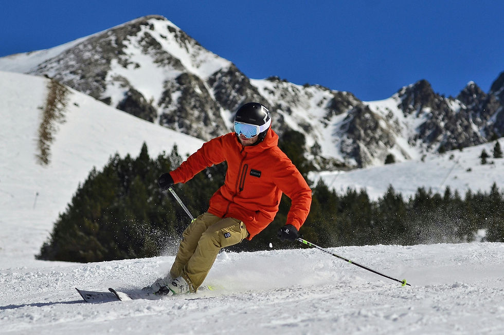 In this photograph, a skier is swiftly descending the slopes of Tignes ski resort. ALPY winter travel experts employ this image to emphasize the significance of wearing proper ski gear, including a ski jacket, for novice skiers.