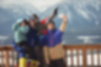 A family in Grimentz takining a photo. Grimentz is one of the destinations ALPY winter travel experts advise to take your family. In the photo the family is seen waving at the camera