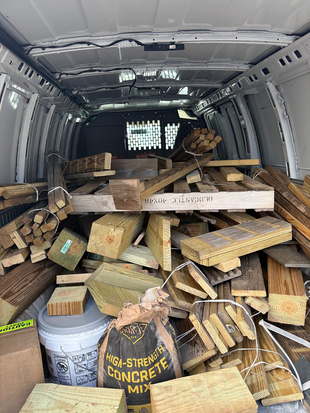 Construction debris loaded into the back of a van for disposal