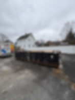 A flattened 20 yard container, with no excess refuse outside of it.