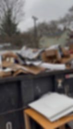 Excess garbage outside of a 20 yard dumpster