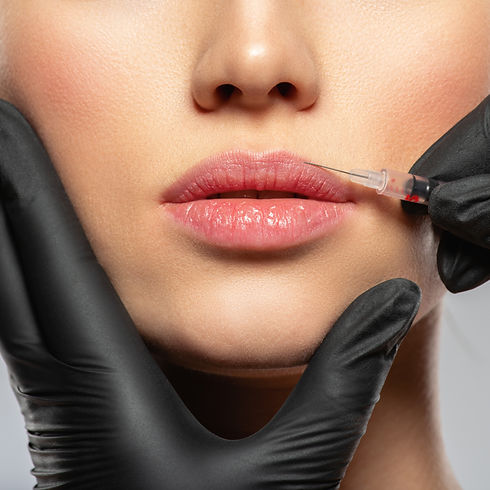 Young caucasian woman getting botox cosmetic injection in the lips. Beautiful woman gets b