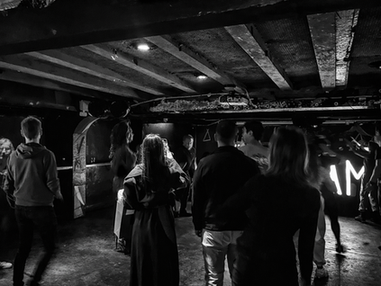 People dancing at a sober afternoon rave in Dublin with low lighting and electronic music.