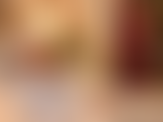 Elderly woman living alone smiling in bed at night while talking on the phone, with her home share companion checking on her for overnight reassurance