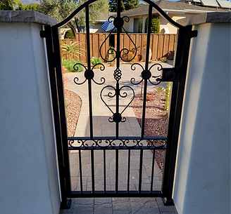 iron metal pedestrian gate with ornamental hand forged scroll ironwork.png