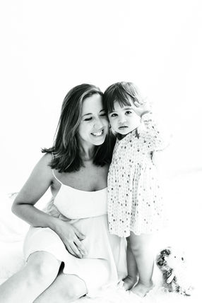 Pregnant mother with her child during an intimate maternity photoshoot at home in Delft, natural lifestyle pregnancy photography