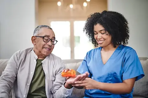caregiver-giving-medication-to-senior-man.480x0.webp