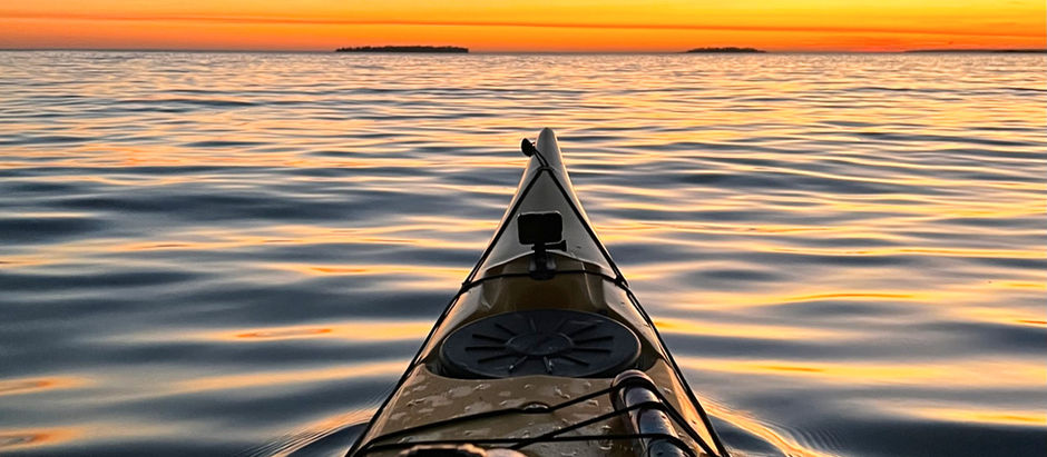 kayak facing the sunset