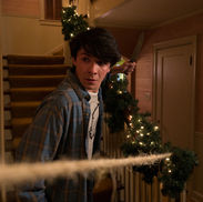 Featuring actor Sloane Morgan Siegel walking down stairs while holding a knife. A string is in front of him, attached to the bottom banister and somewhere off screen.