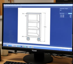 Cad drawing of a trolly  cabinet with measurements on a computer screenon a desk