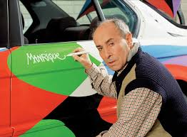 Cesar Manrique visionary, Renaissance man signing a car door