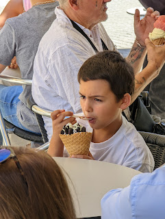 Portuguese boy relishes his ice cream treat in a crowded cafe.