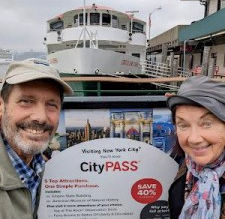 Travel writers Cookie & Keller pose at CityPASS sign at Fishermans Wharf San Francisco